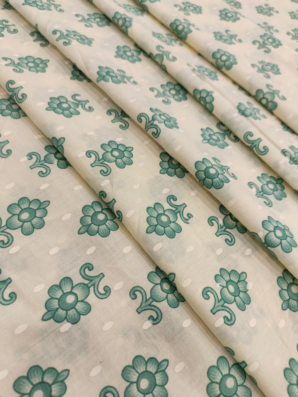 Cream cotton base floral print with green.