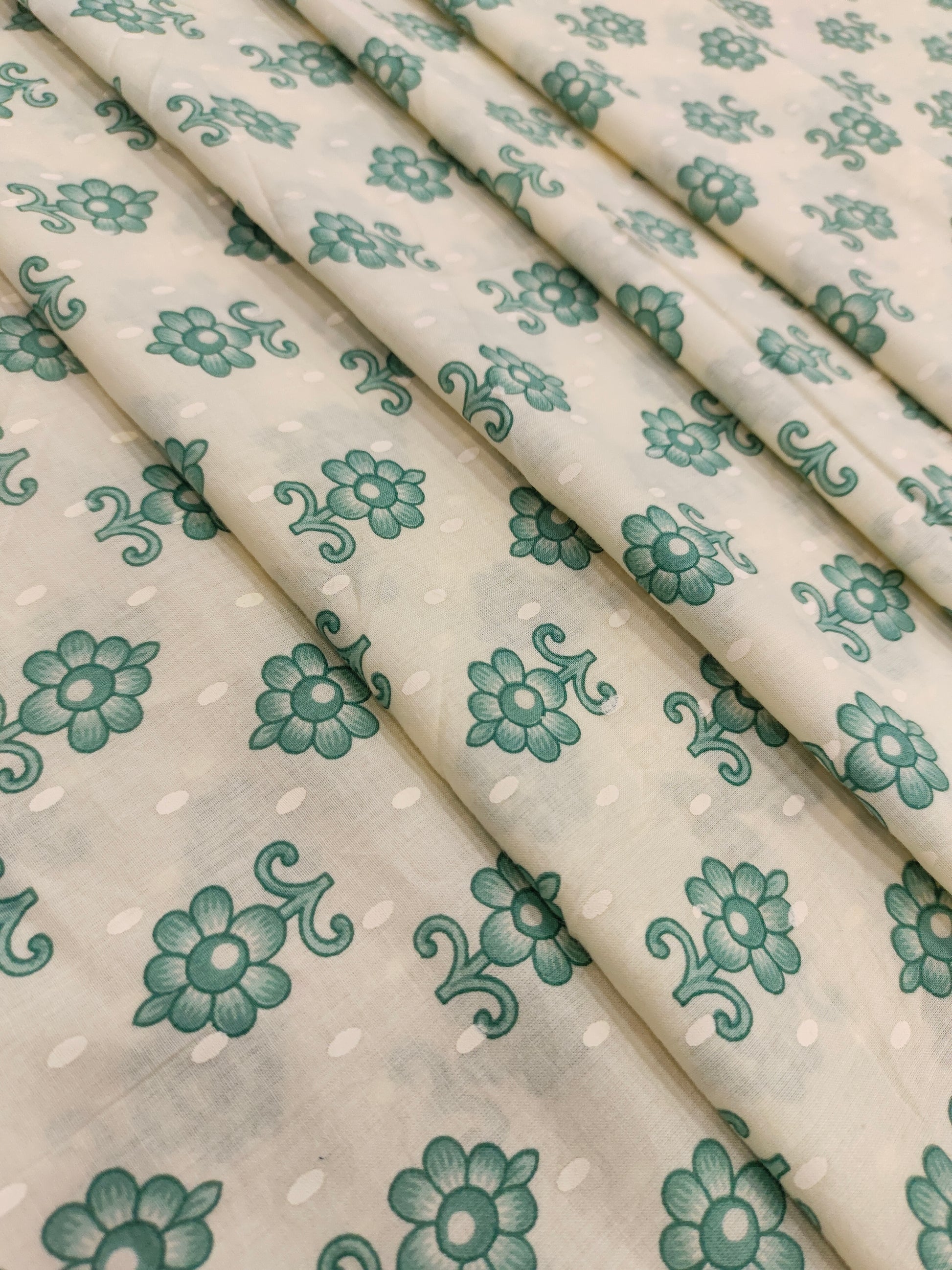 Cream cotton base floral print with green.