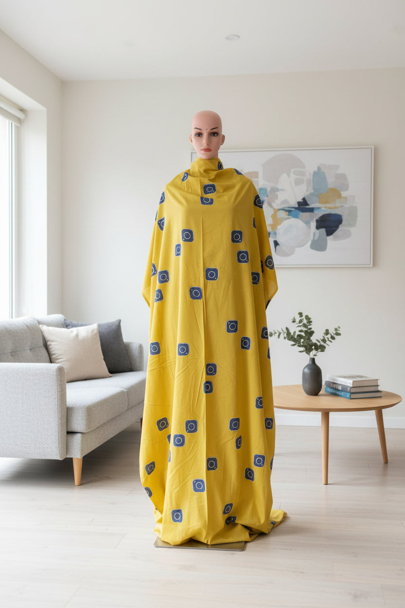 Cotton mustard fabric discharge print with blue in abstract design.