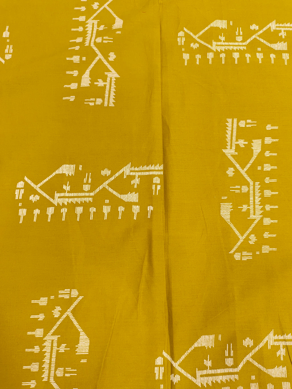 Mustard color cotton fabric with jamdani print in white.