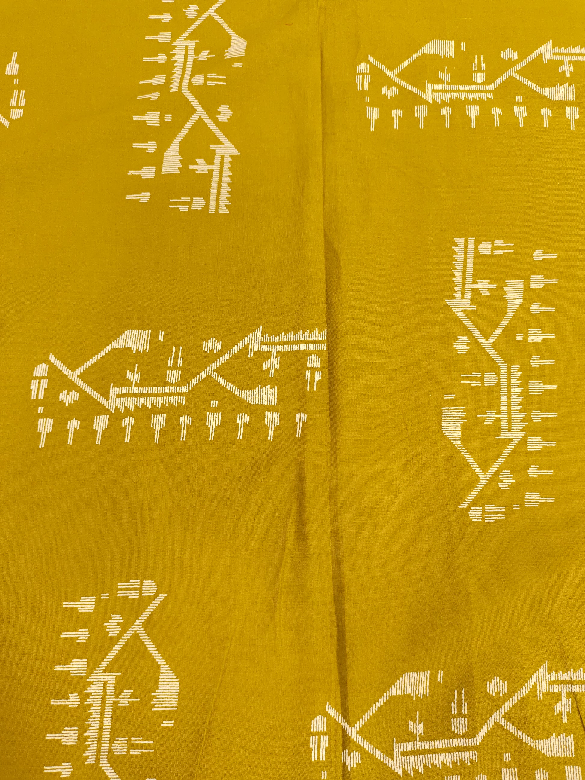 Mustard color cotton fabric with jamdani print in white.