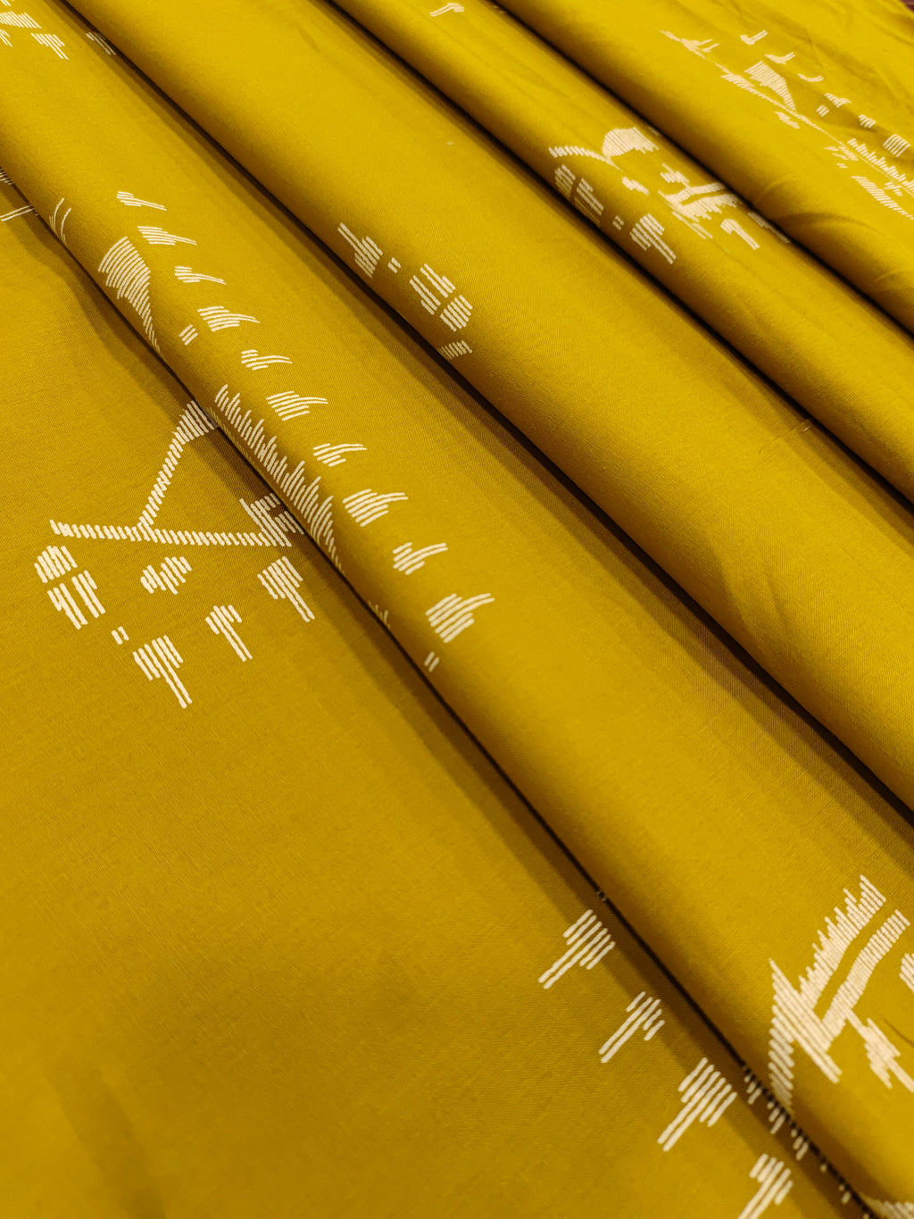 Mustard color cotton fabric with jamdani print in white.