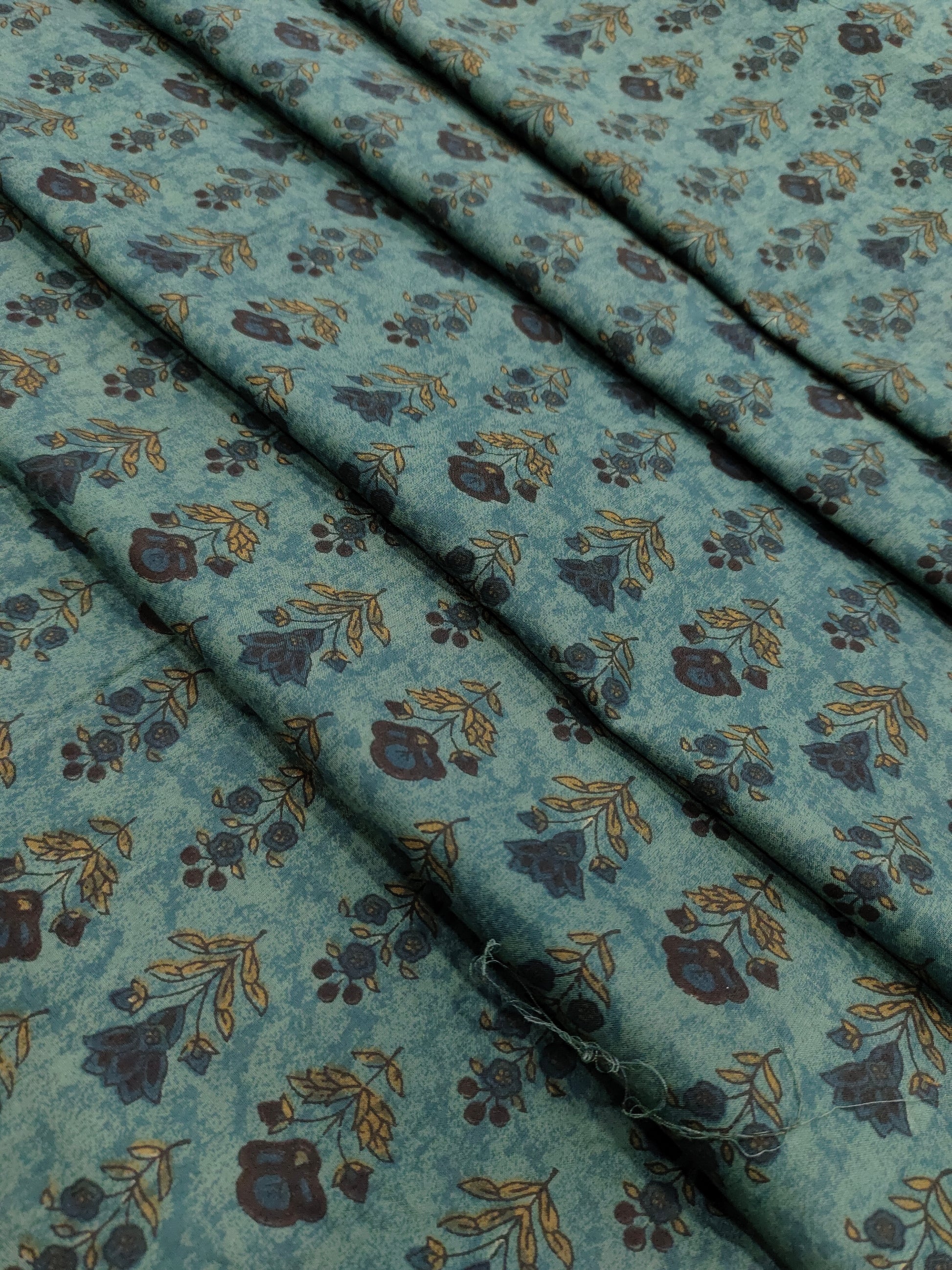 Cotton 60s bagh print butti on peacock green color.