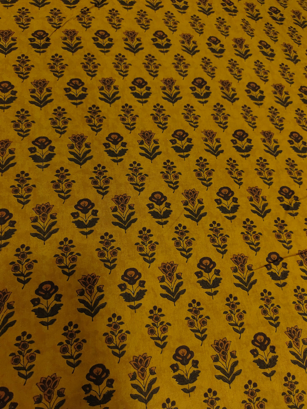 Cotton bagh print on mustard base with brown and green colors in 2 forms of butti.