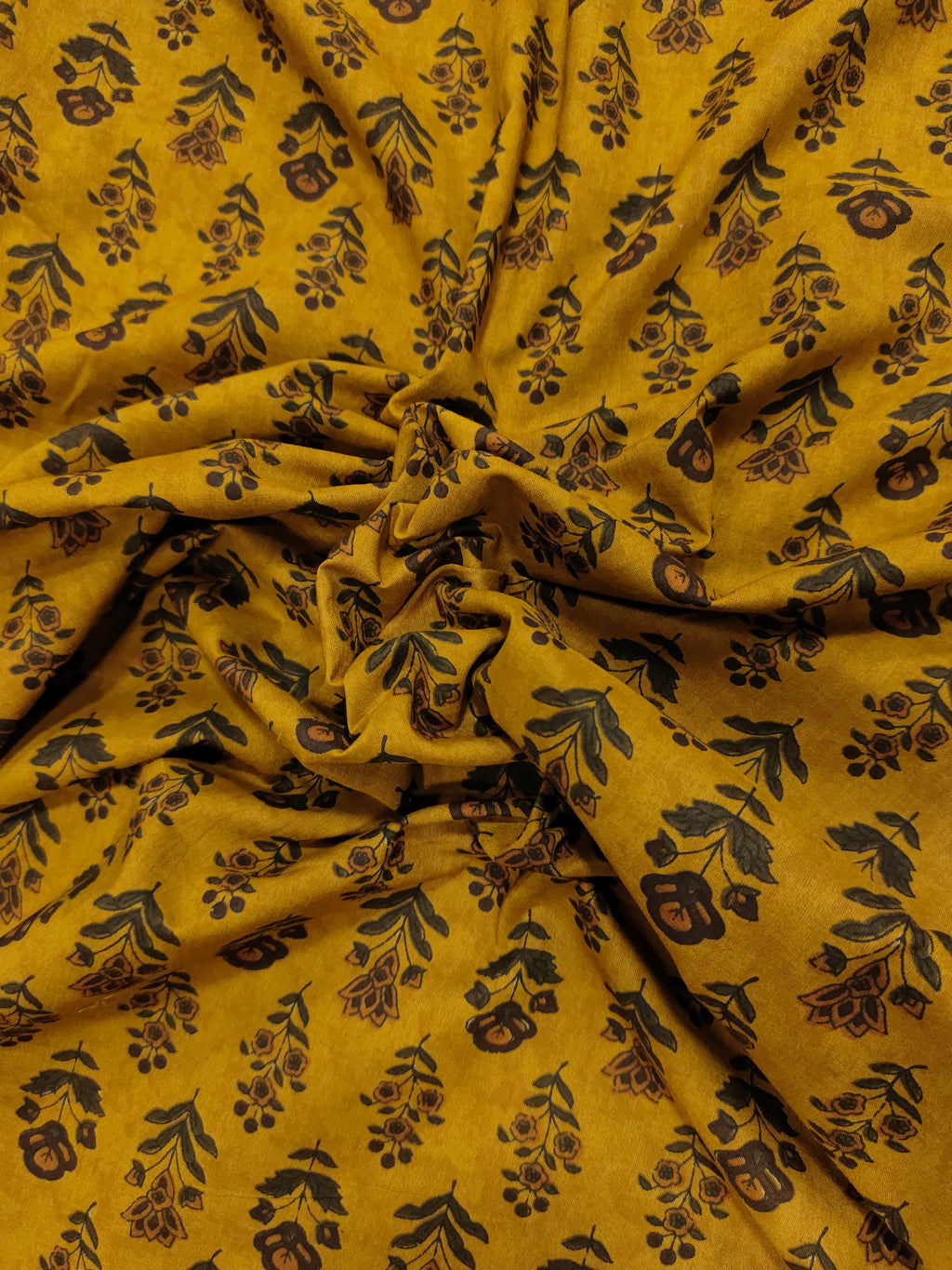 Cotton bagh print on mustard base with brown and green colors in 2 forms of butti.