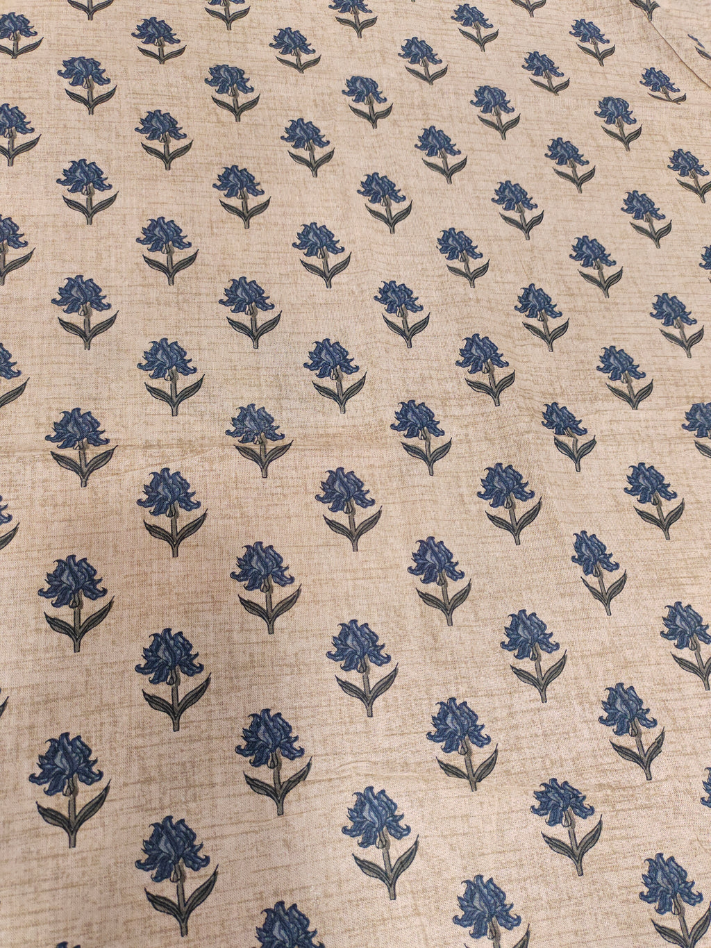Beige flex cotton printed with blue small butti.