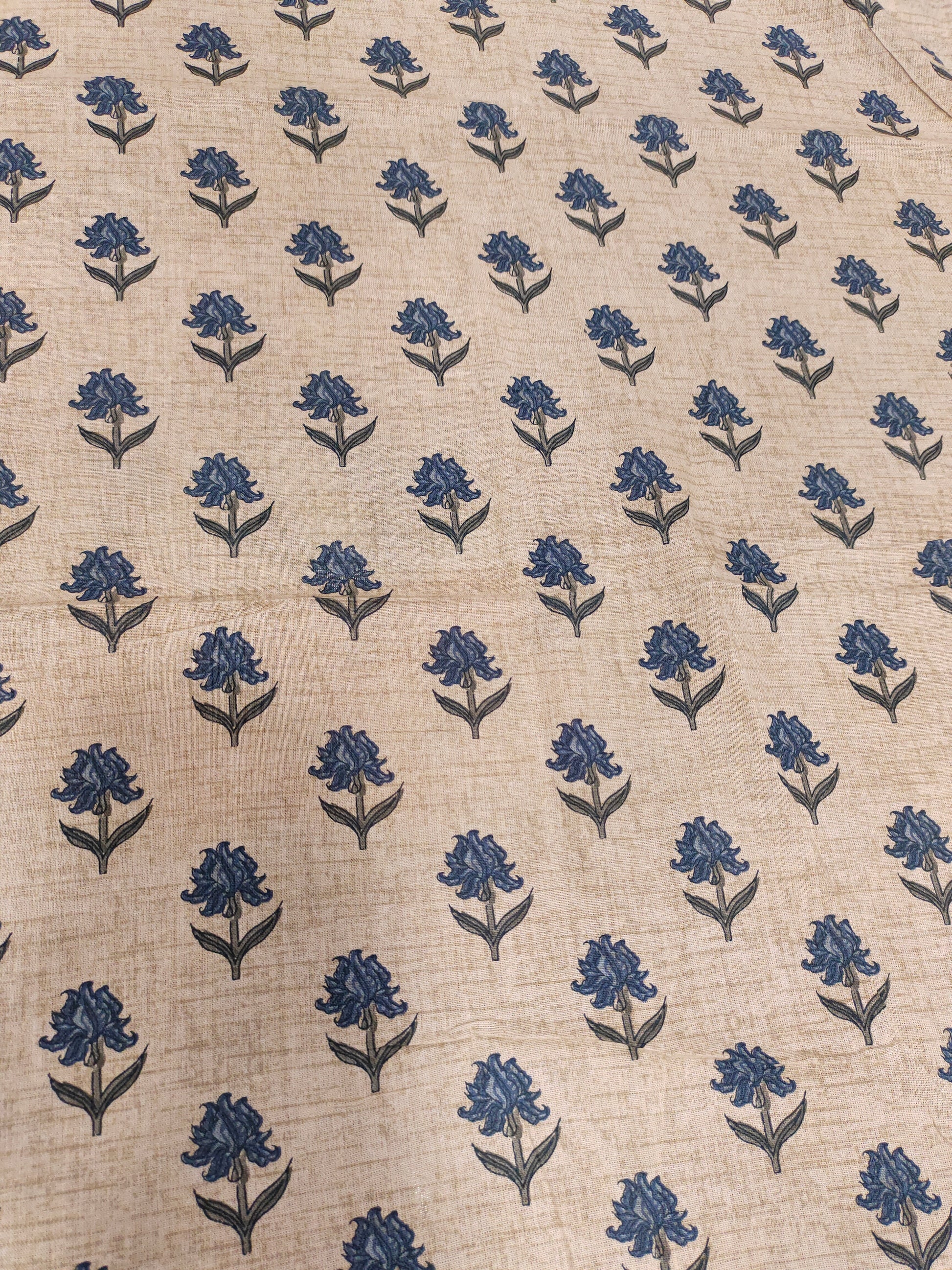 Beige flex cotton printed with blue small butti.