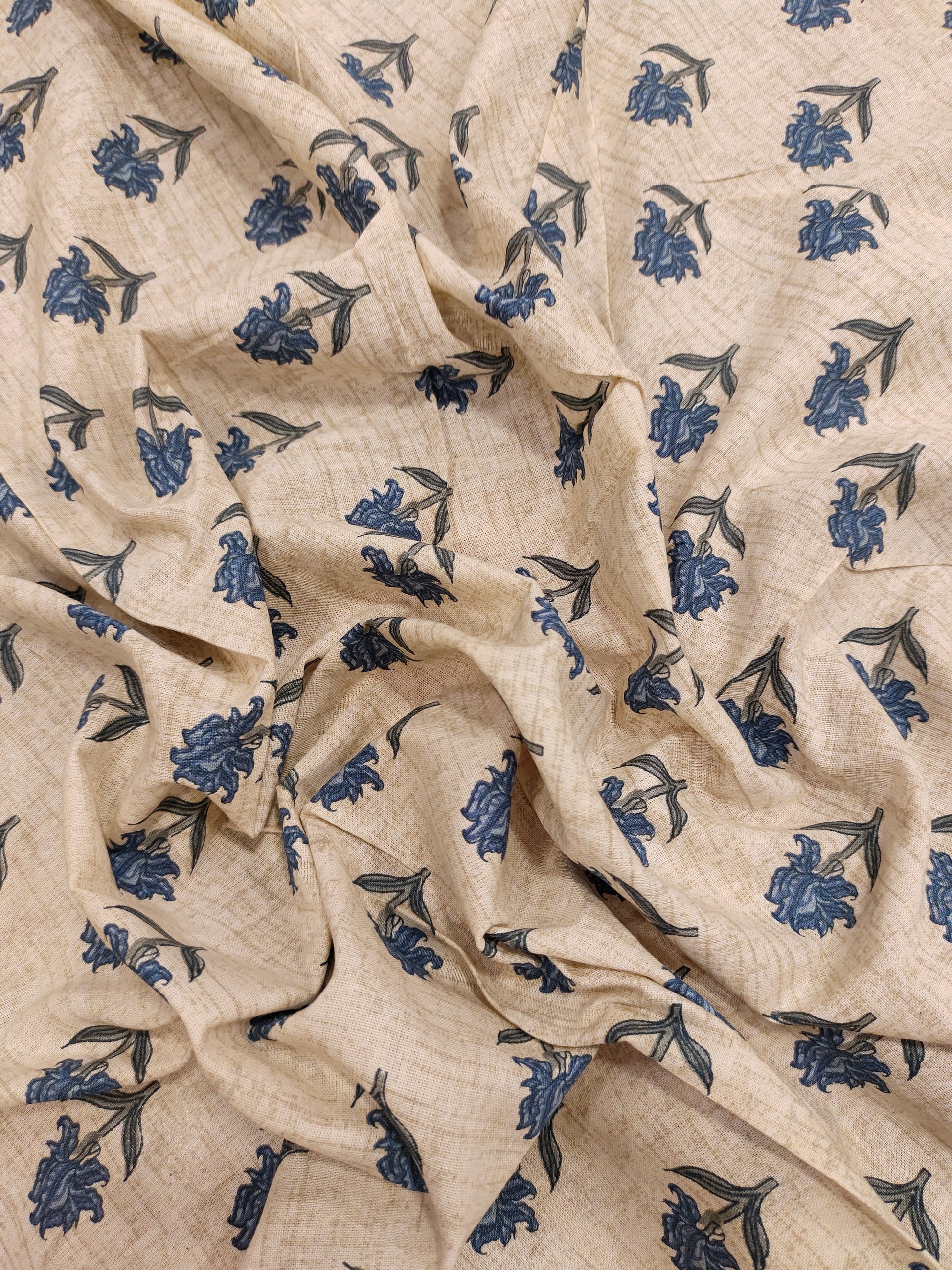 Beige flex cotton printed with blue small butti.