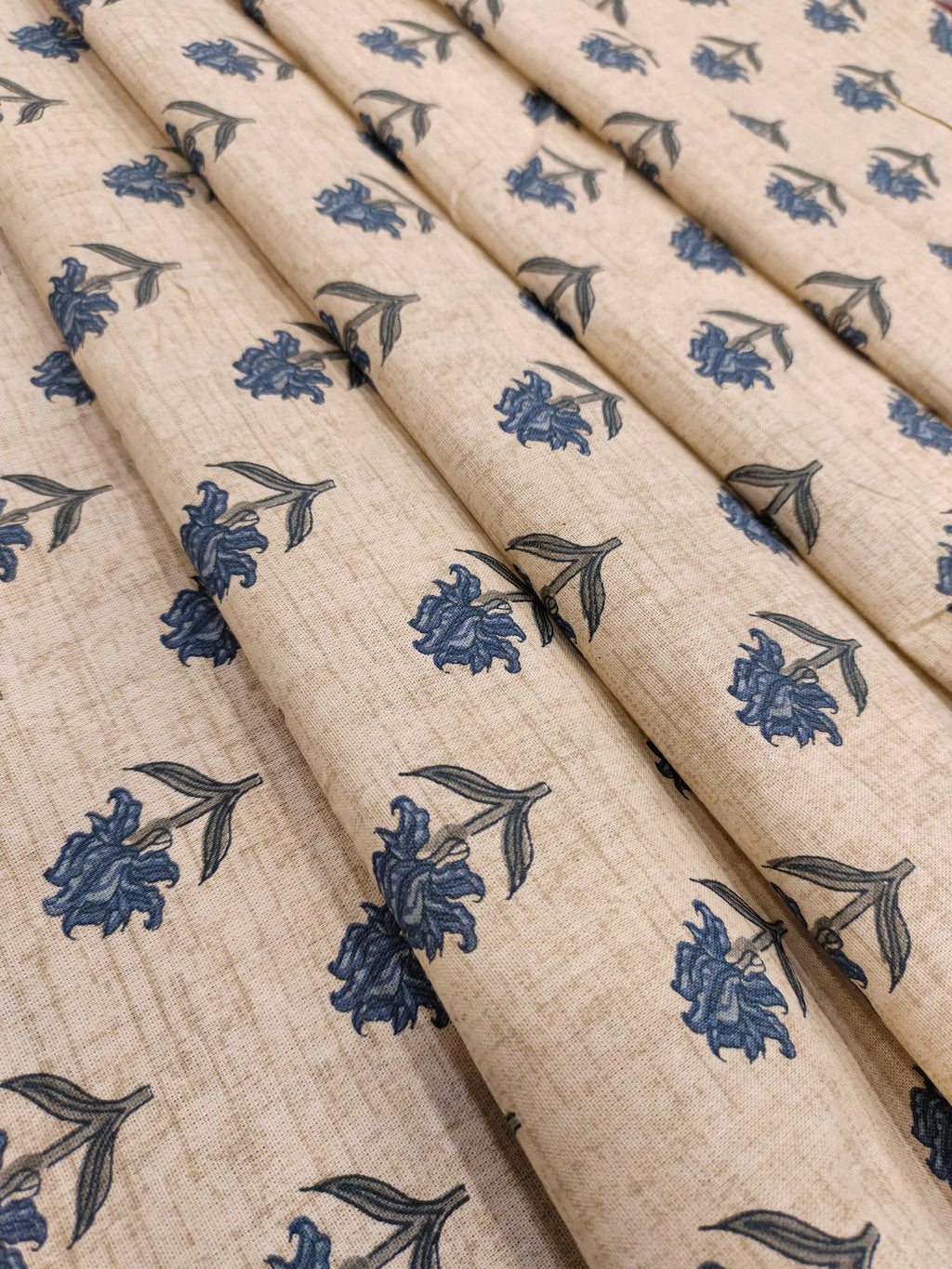 Beige flex cotton printed with blue small butti.