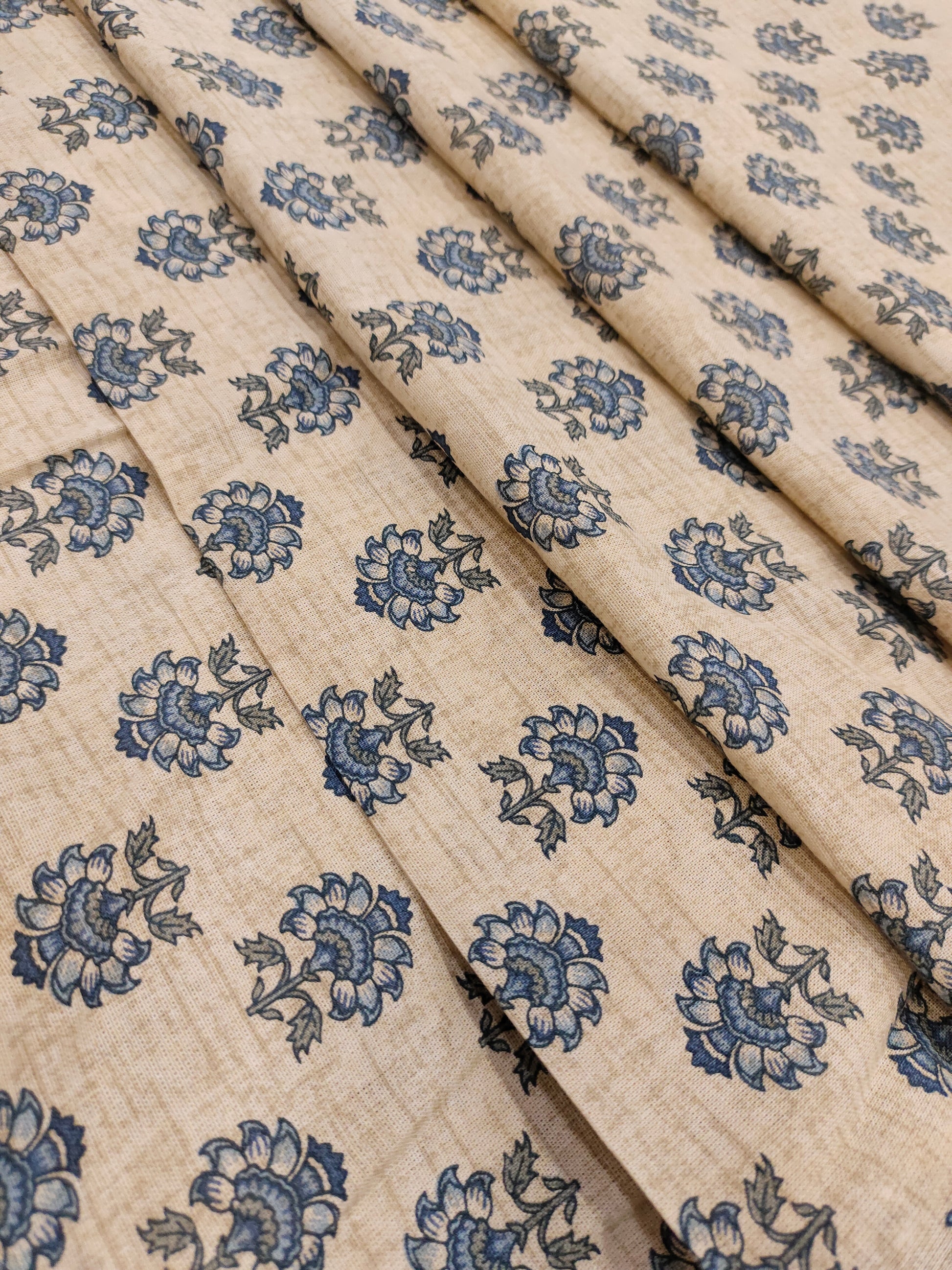 Beige flex cotton fabric with blue pointed flowers.