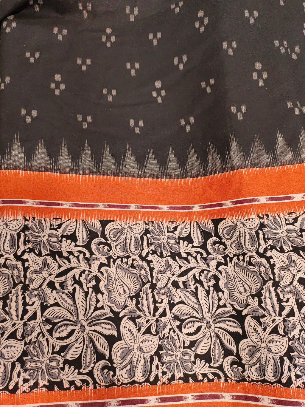 Black printed rust daman print on cotton fabric.