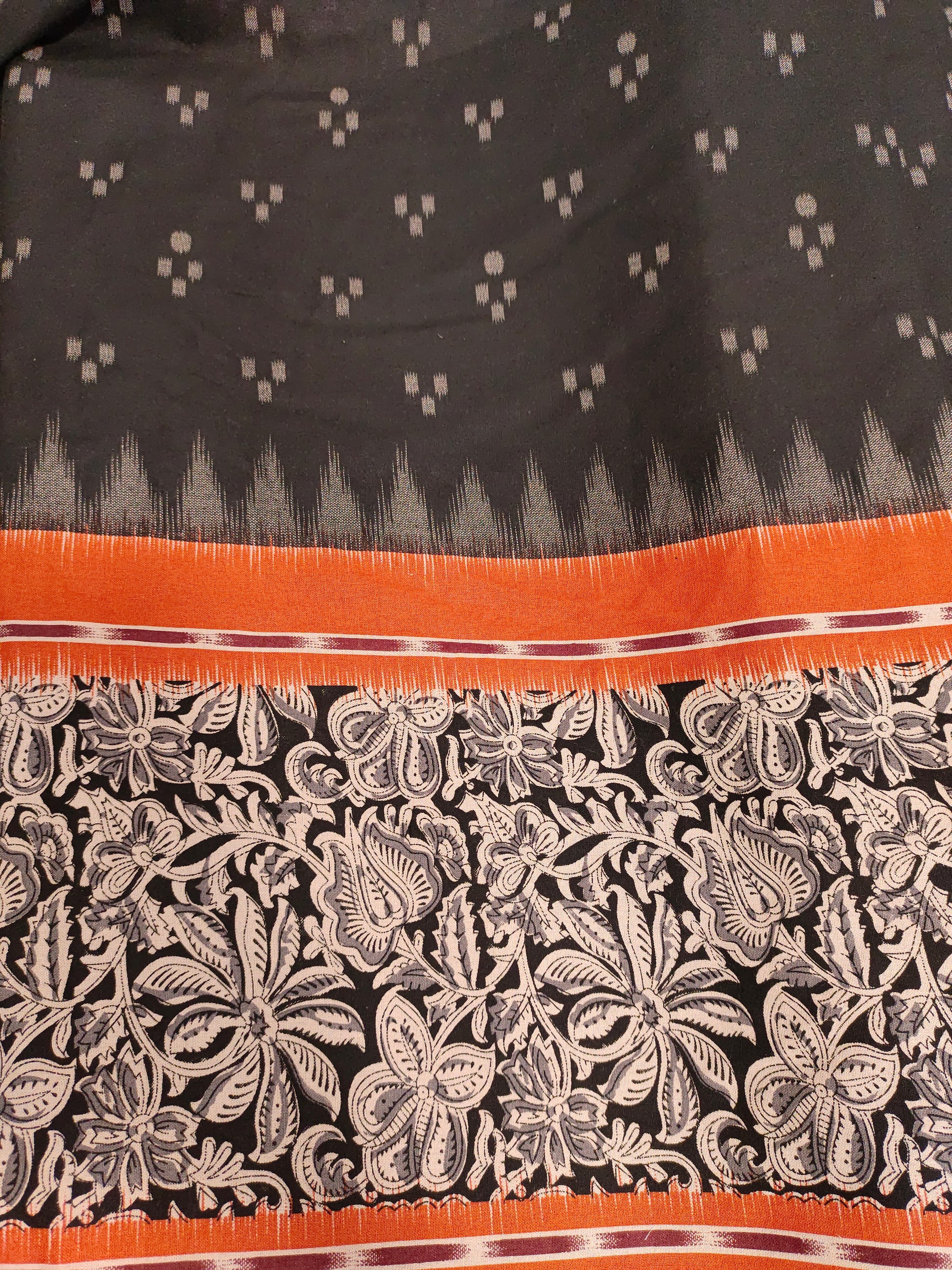 Black printed rust daman print on cotton fabric.