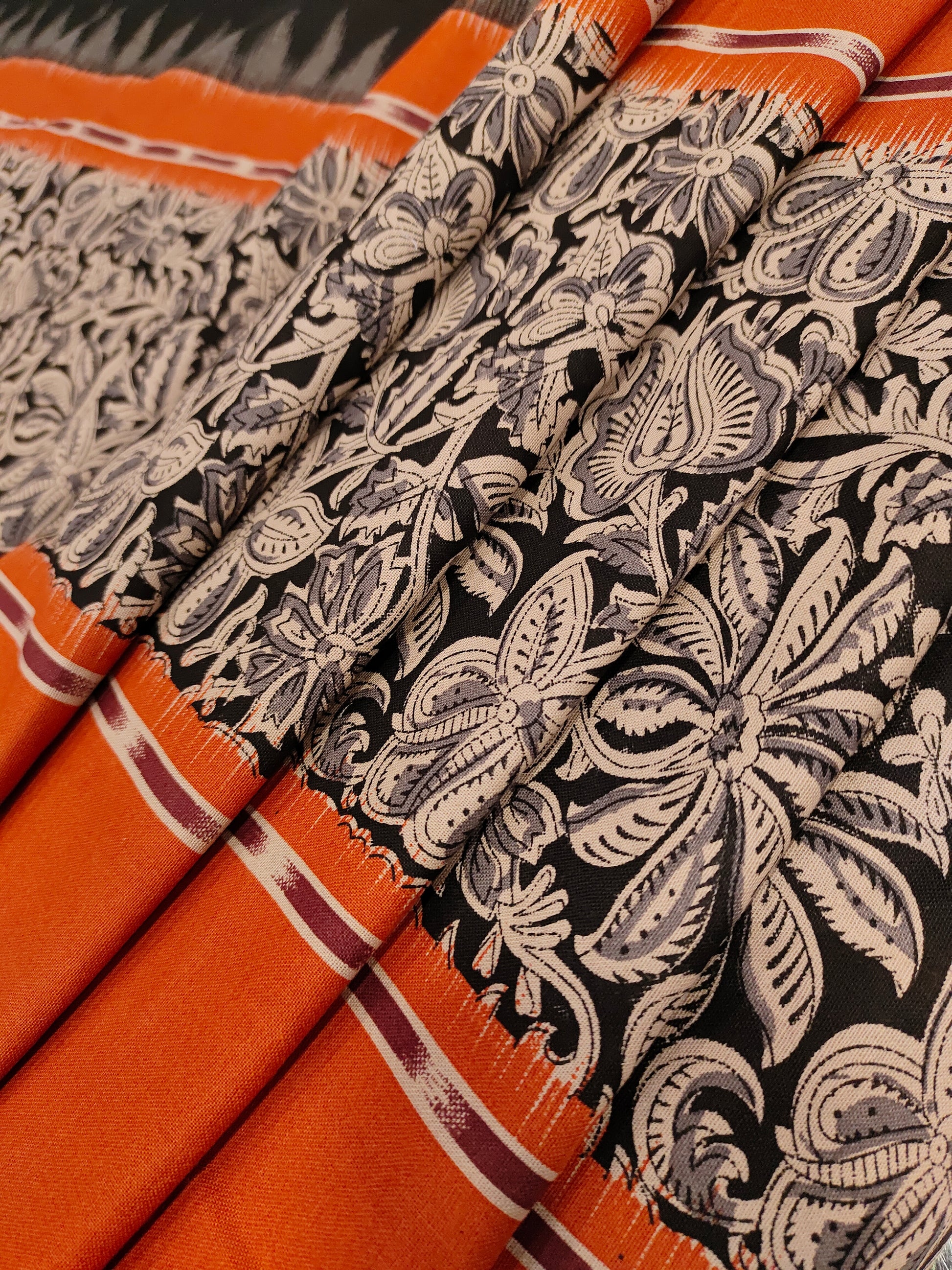 Black printed rust daman print on cotton fabric.