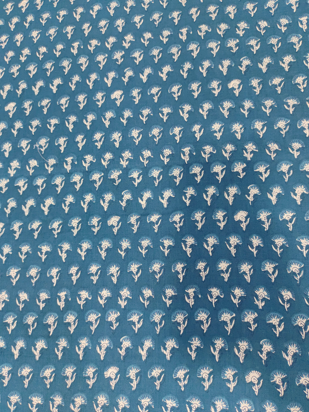 Bluish green fabric with small off-white buttis on cotton fabric.