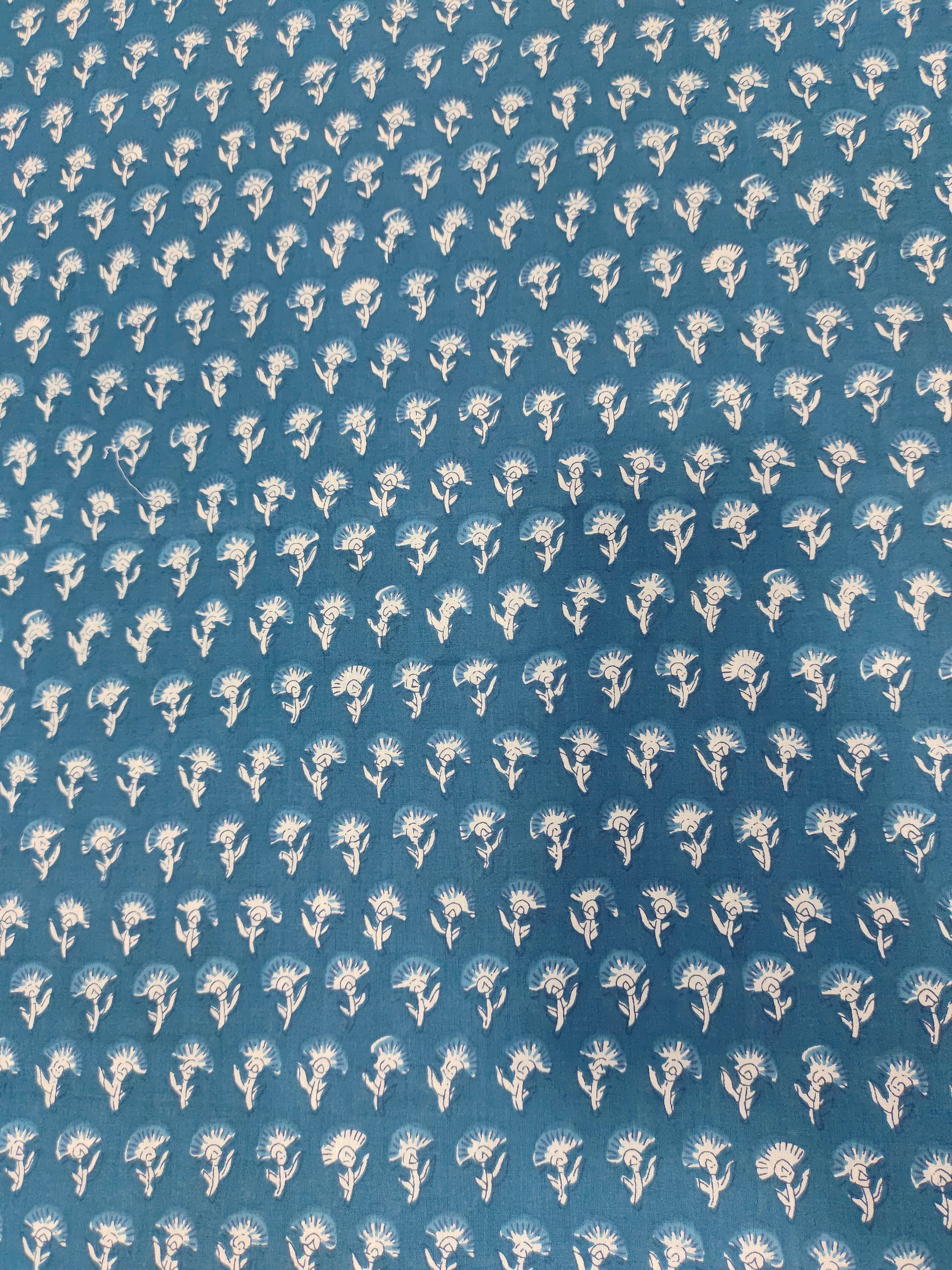 Bluish green fabric with small off-white buttis on cotton fabric.