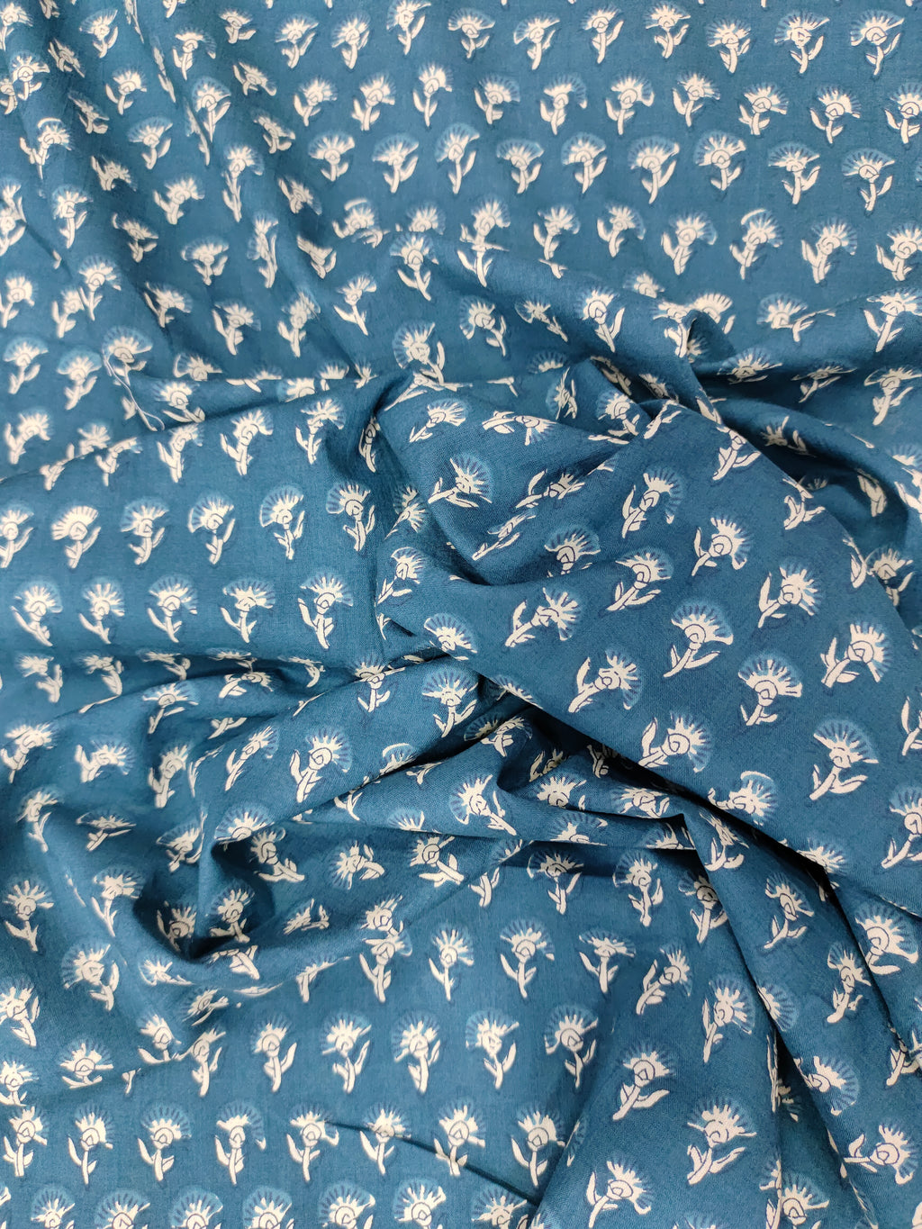 Bluish green fabric with small off-white buttis on cotton fabric.