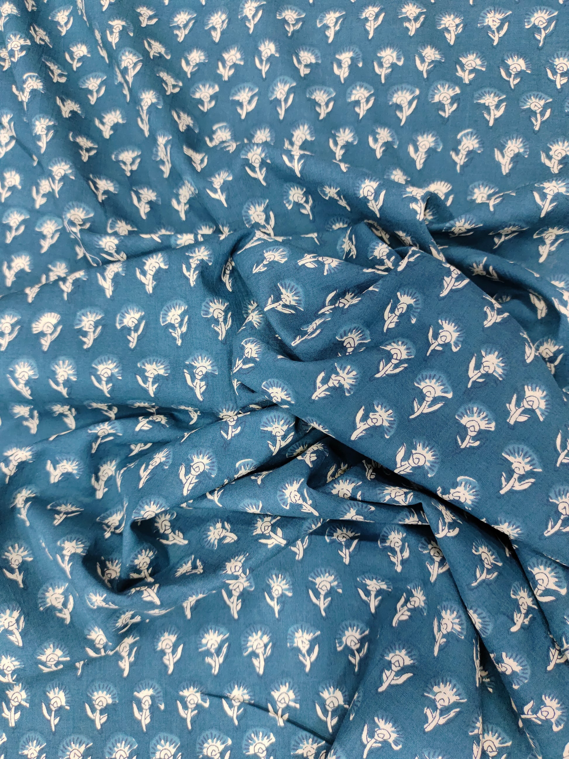Bluish green fabric with small off-white buttis on cotton fabric.