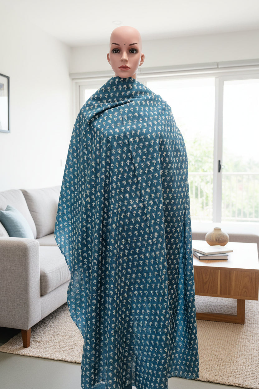 Bluish green fabric with small off-white buttis on cotton fabric.