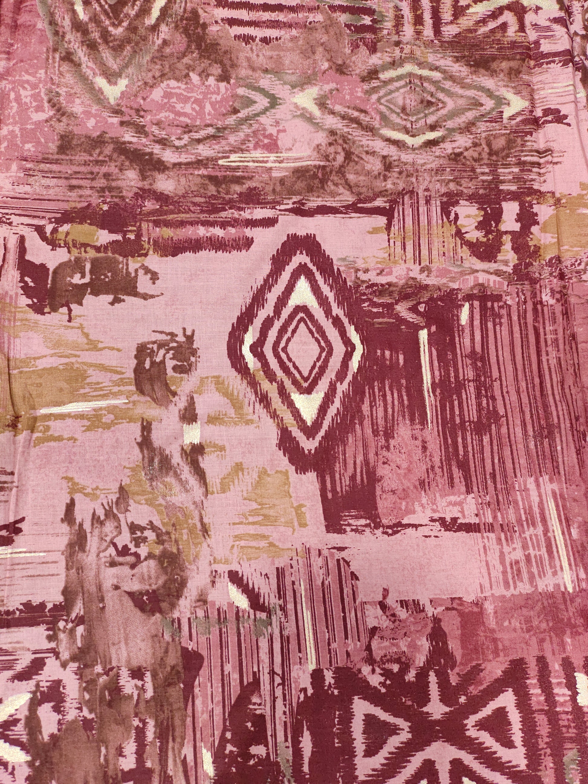 Cotton abstract print with little gold foil in maroon and pink colors.