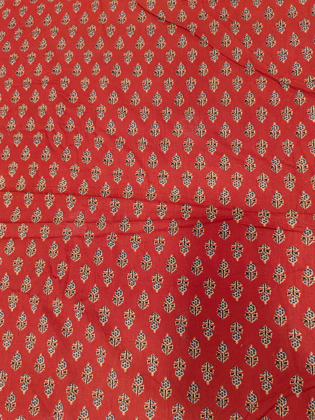 Maroon cotton print with blue and beige with small buttis.