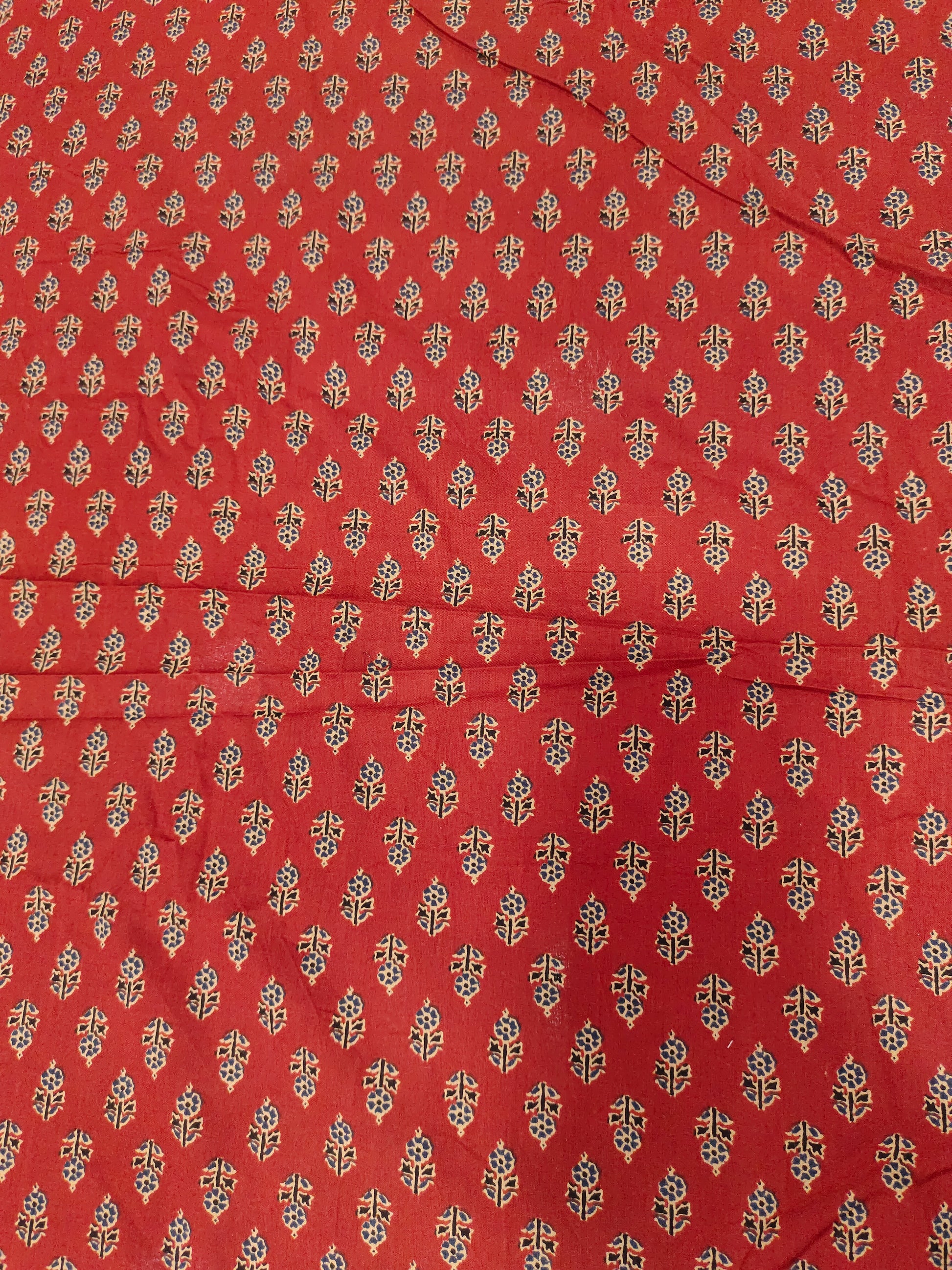 Maroon cotton print with blue and beige with small buttis.
