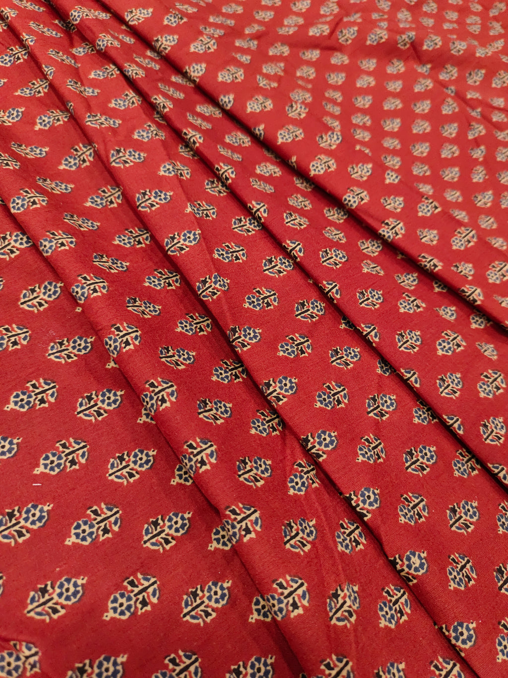 Maroon cotton print with blue and beige with small buttis.