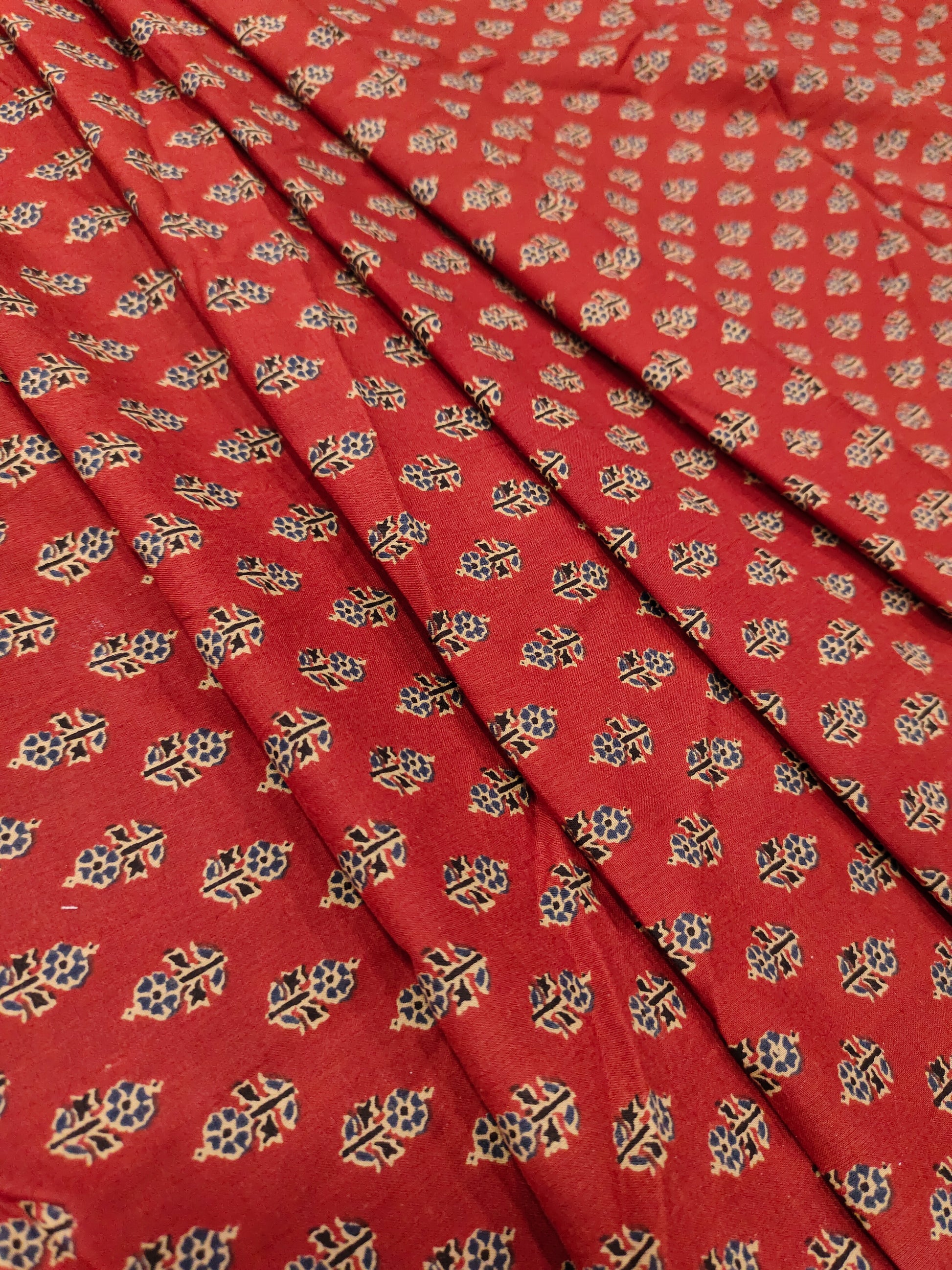 Maroon cotton print with blue and beige with small buttis.