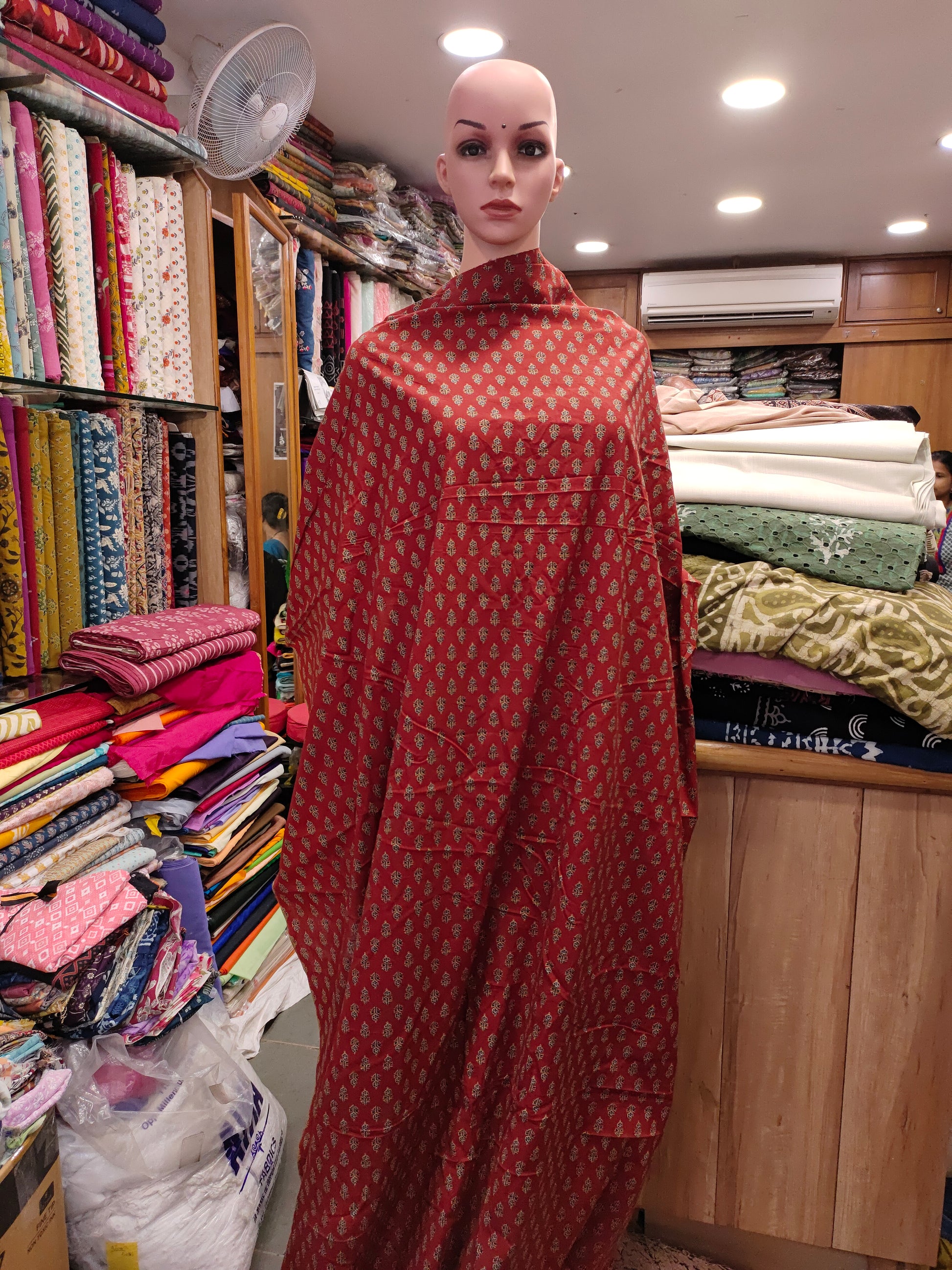 Maroon cotton print with blue and beige with small buttis.